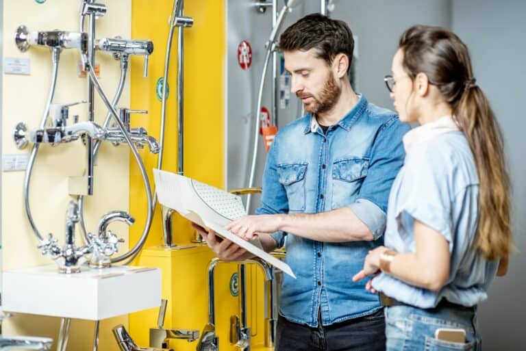 Couple choosing shower faucet in the shop